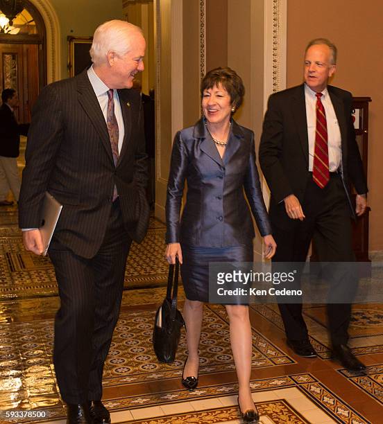 Senator Susan Collins, , center and Sen. John Cornyn , left, walk through the halls of the U.S. Capitol after a caucus meeting with fellow...