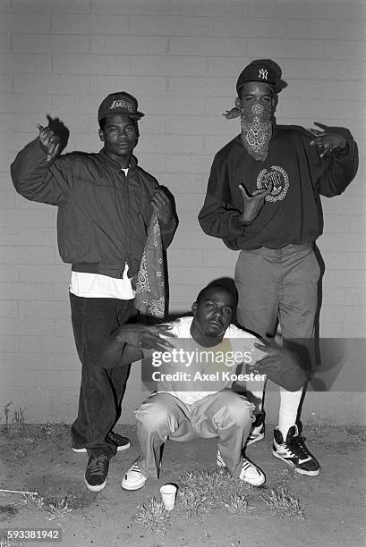 Members of the Grape Street Crips pose "throwing" their signature 'G' and 'W' hand signs. The Grape Street Watts Crips are a mostly African American...