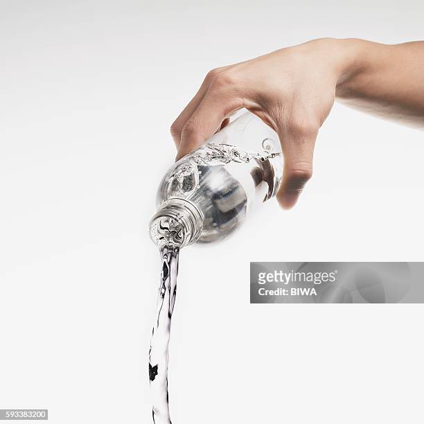 water pouring out of plastic bottle - fülle stock-fotos und bilder