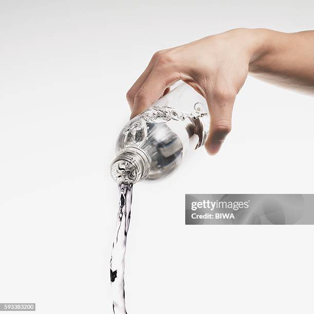 water pouring out of plastic bottle - chorro agua fotografías e imágenes de stock