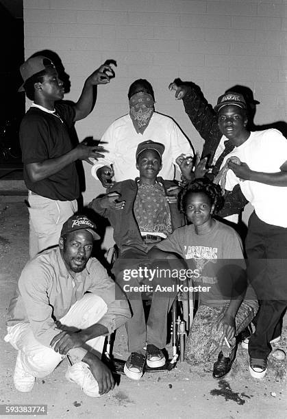 Members of the Grape Street Crips pose "throwing" their signature 'G' and 'W' hand signs. The Grape Street Watts Crips are a mostly African American...