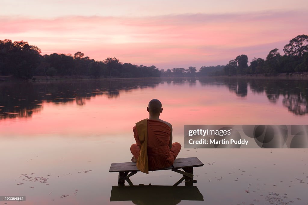 Cambodia, Angkor Wat, Buddhist Monk at sunset