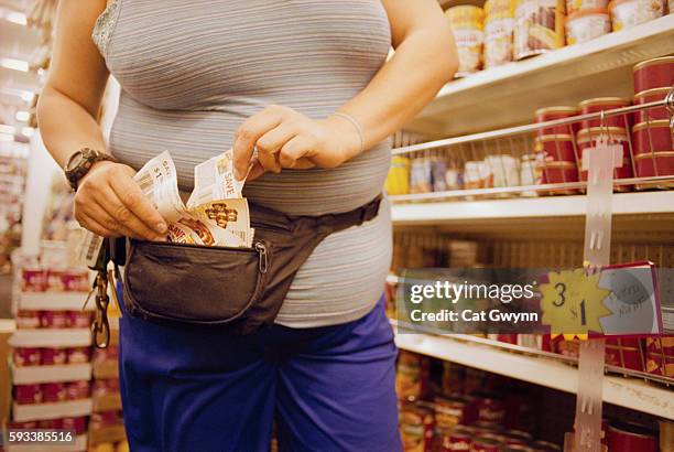 woman using coupons while shopping - coupons stock pictures, royalty-free photos & images