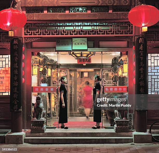 waitresses greet customers at restuarant entrance - cafe front stock pictures, royalty-free photos & images