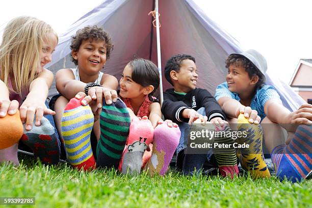 children wearing coloured socks outside tent - crazy socks stock pictures, royalty-free photos & images