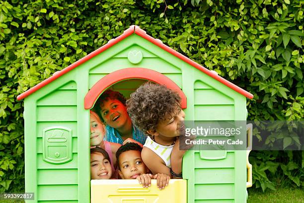 children on playhouse in garden - playhouse stock-fotos und bilder