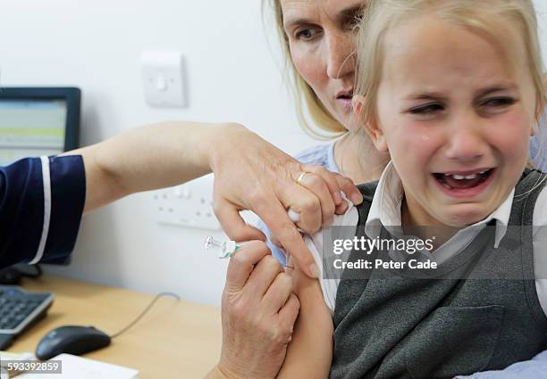 young girl getting injection - children vaccination stock pictures, royalty-free photos & images