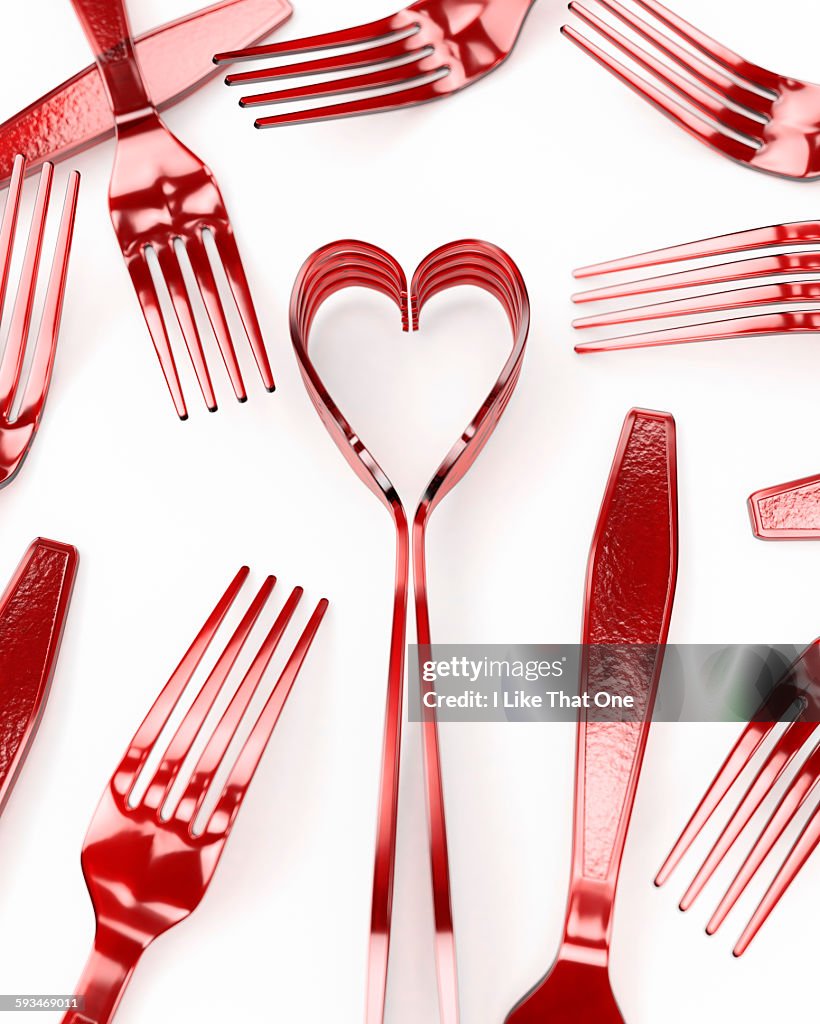 Forks on a white surface depicting a heart