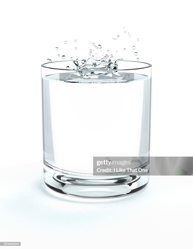 Glass of water with water splash on surface