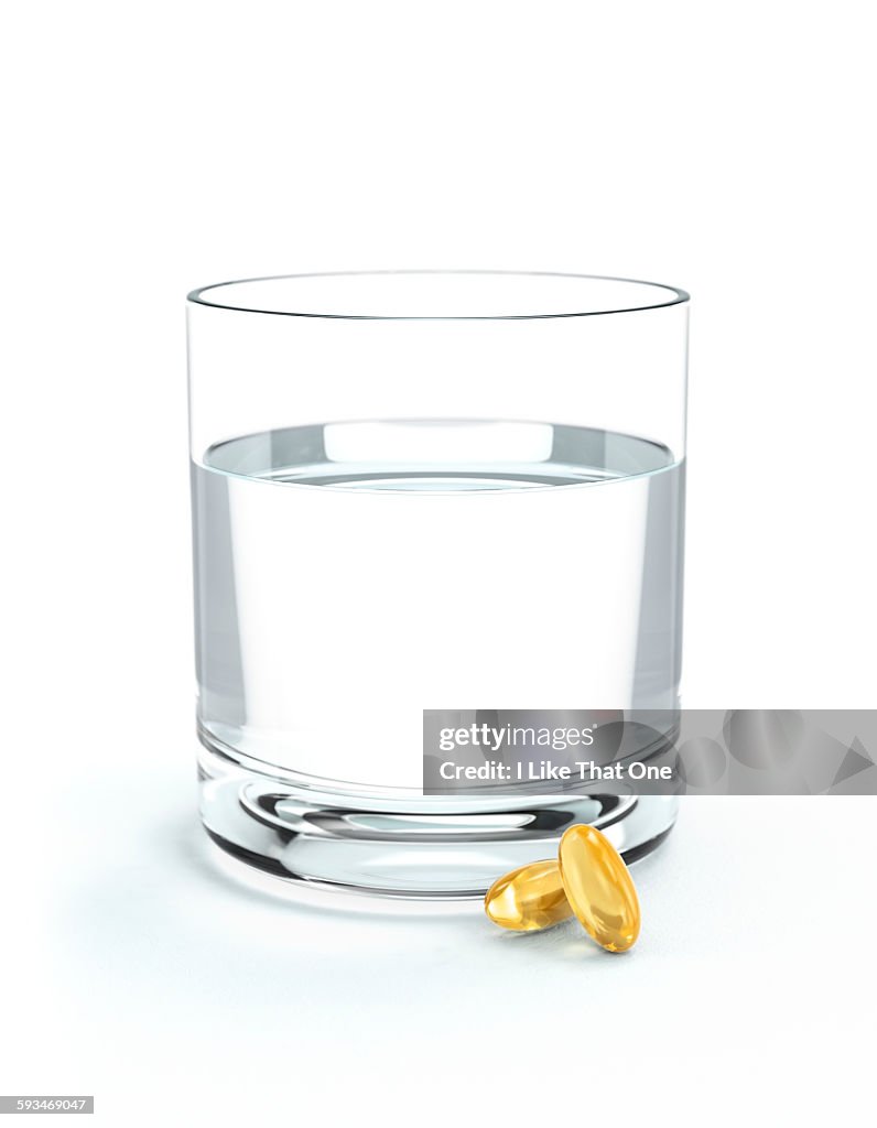 Glass of water and oil supplements