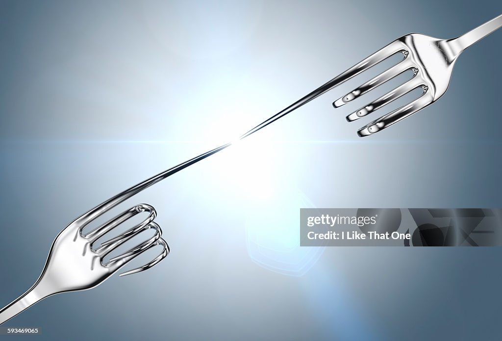 Two silver forks reaching out to each other