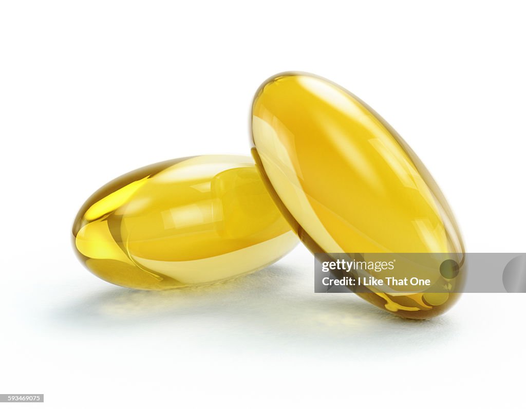 Oil / medication pill capsules on white surface