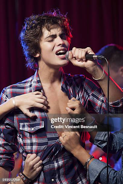 singer on stage is making rip his shirt - shirt ripping stock pictures, royalty-free photos & images