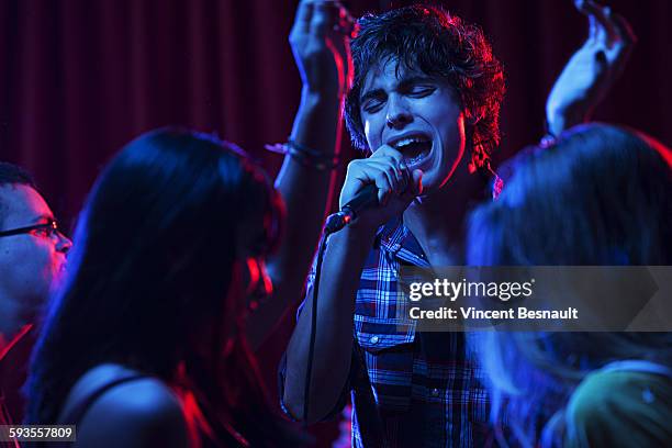 singer on stage during a concert - illuminated portrait stock pictures, royalty-free photos & images