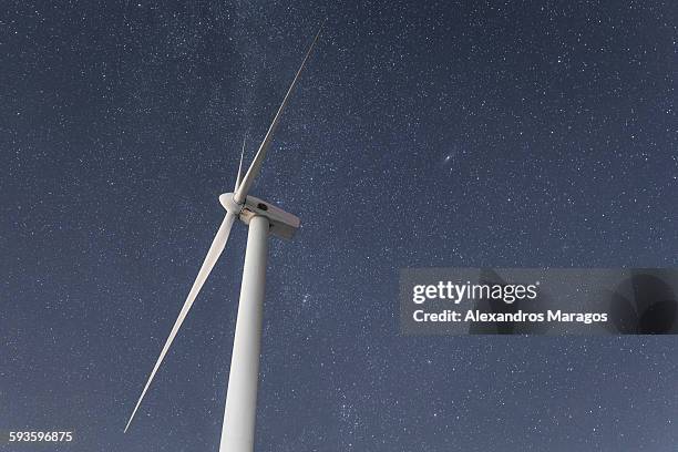 wind turbine under the night sky - alexandros maragos stock pictures, royalty-free photos & images