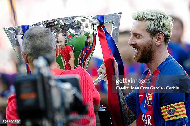 Lionel Messi and Andrés Iniesta of F.C.Barcelona showing the 2015 Spanish League champions cup, before the Spanish League match between F.C Barcelona...