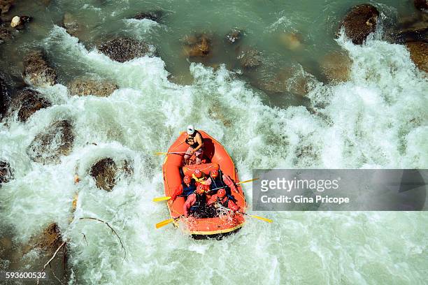 rubber dinghy with tourists doing rafting in trentino, italy. - river rafting stock pictures, royalty-free photos & images