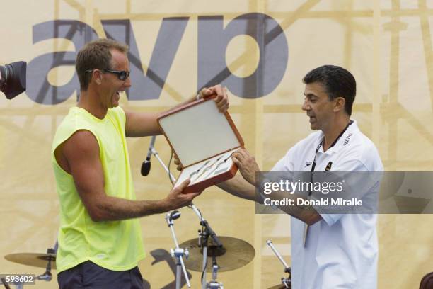 Owner and CEO of the Association of Volleyball Professionals Leonard Armato presents Sinjin Smith with a set of watches upon his retirement at the...