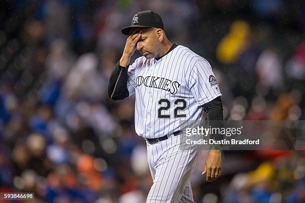 Walt Weiss of the Colorado Rockies rubs his forehead after making a pitching change in the 10th inning of a game against the Chicago Cubs at Coors...