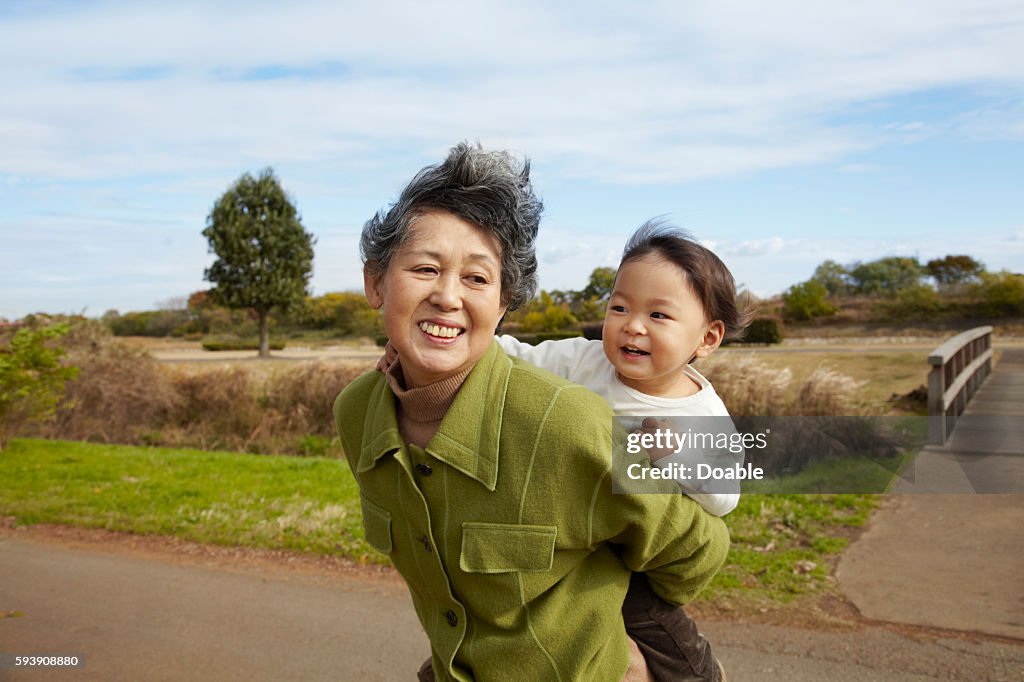 Grandmother Carrying Granson