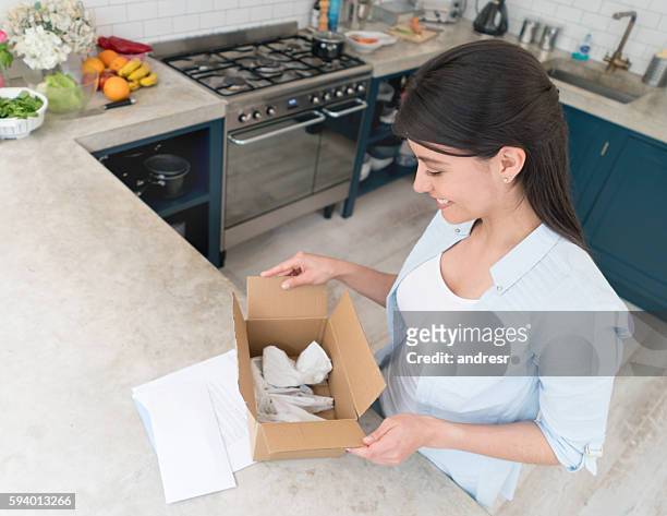 woman getting a package on the mail - care package stock pictures, royalty-free photos & images