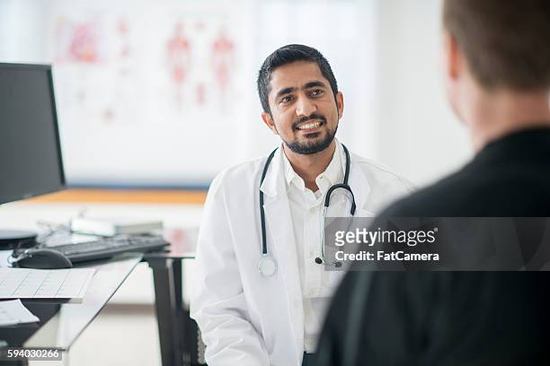 talking to a doctor during a check up - man talking to camera stock pictures, royalty-free photos & images