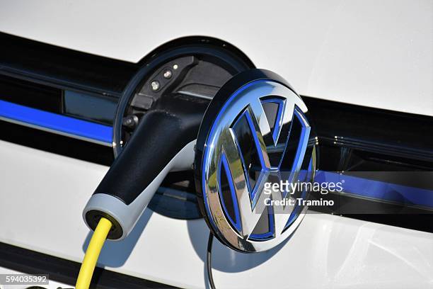 charging process in a modern volkswagen golf gte - volkswagen stock pictures, royalty-free photos & images