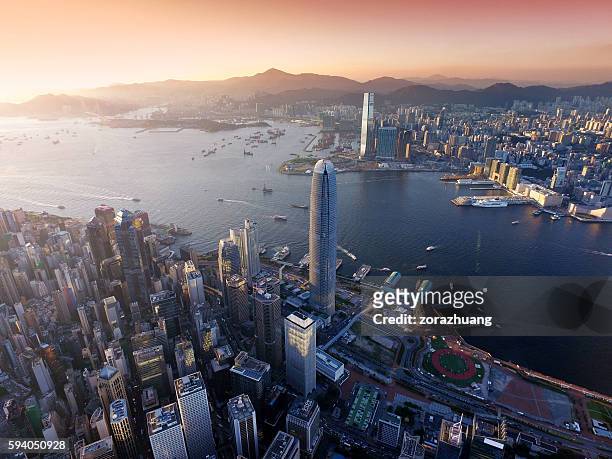 aerial view of hong kong city, victoria harbour in sunset - hong kong imagens e fotografias de stock