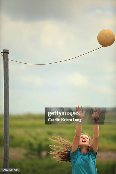 girl playing tetherball. - tether ball stock pictures, royalty-free photos & images