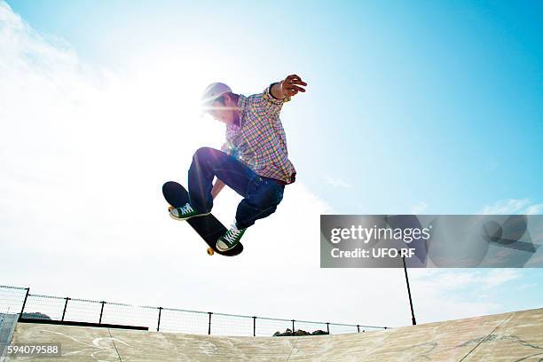 one young man skateboarding - skating ストックフォトと画像