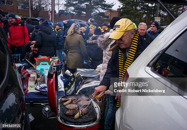 Unidentified fans and alumni of the University of Michigan and Ohio State University socialize with tailgate parties before the Big Ten football...