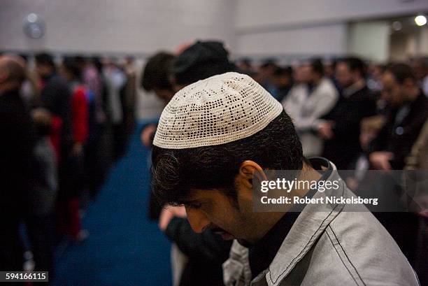 Unidentified men pray in a mosque during a Friday prayer service given by Imam Mohamed Almasmari at the Muslim Unity Center in Bloomfield Hills,...