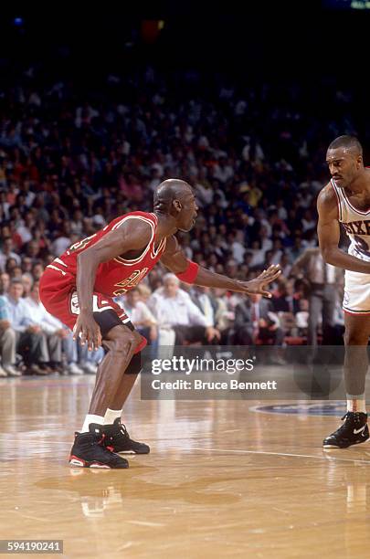 Michael Jordan of the Chicago Bulls defends against Hersey Hawkins of the Philadelphia 76ers during a game in the 1991 Eastern Conference Semifinals...