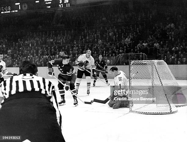 Goalie Glenn Hall of the Chicago Blackhawks and Phil Goyette of the New York Rangers battle for the puck on October 27, 1963 at the Madison Square...