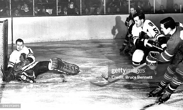 Goalie Glenn Hall of the Chicago Blackhawks can't make the save on the shot by Frank Mahovlich of the Toronto Maple Leafs as Hall's teammate Jack...