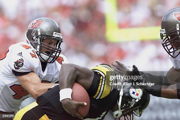 John Lynch of the Tampa Bay Buccaneers tackles quarterback Kordell Stewart of the Pittsburgh Steelers during the game at Raymond James Stadium in...