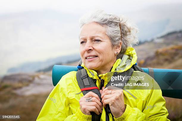 older woman trekking in the mountains of ireland - irish woman stock-fotos und bilder