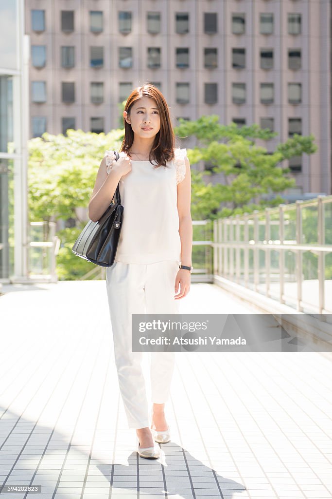 Business woman walking in city location