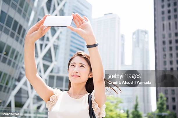 business woman taking self portrait - atsushi yamada stock pictures, royalty-free photos & images