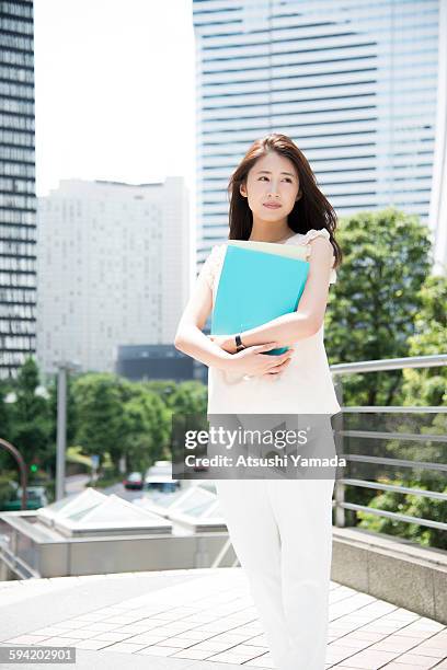 business woman holding files - atsushi yamada stock pictures, royalty-free photos & images