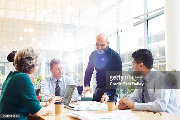 an impromptu brainstorm meeting in modern office. - business finance and industry photos stock pictures, royalty-free photos & images