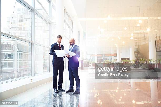 business men discussing plans in modern office - lobby stock pictures, royalty-free photos & images