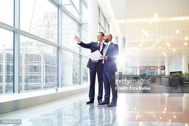 business men discussing plans in modern office - finanzwirtschaft und industrie stock-fotos und bilder