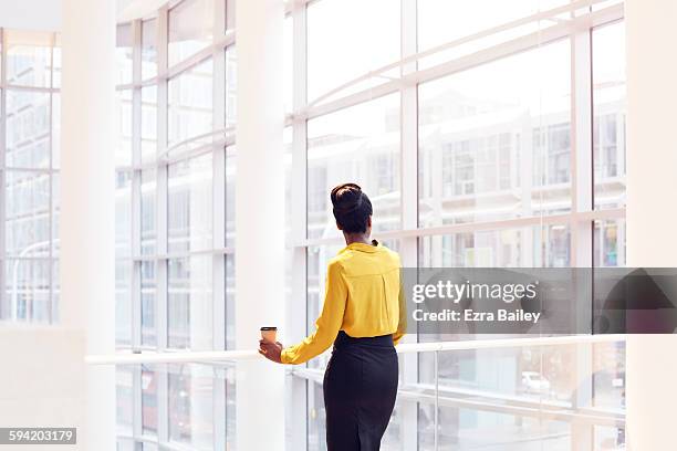 modern business woman looking out the window. - rezar stock pictures, royalty-free photos & images