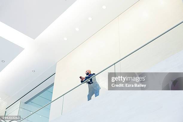 businessman looking out from a balcony. - hall of the people stock pictures, royalty-free photos & images