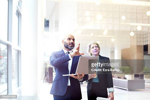 business people discussing plans in modern office. - gelegenheit stock-fotos und bilder
