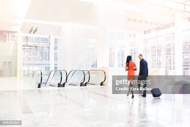 business people walk through large  modern space. - blurred motion business stock pictures, royalty-free photos & images