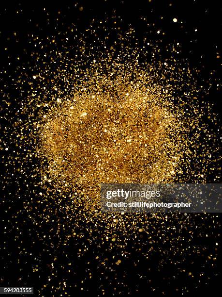 golden glitter explosion - gold glitter foto e immagini stock