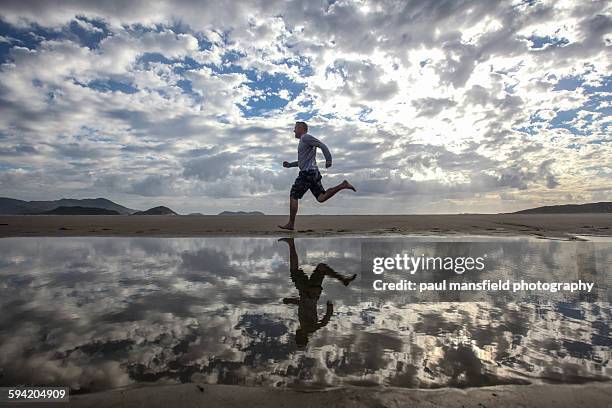 man running on beach - florianópolis imagens e fotografias de stock