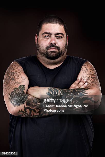 strong man with tattooed arms crossed - sleeveless shirt stock pictures, royalty-free photos & images